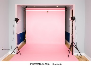 Photography Studio Setup For A Photo Shoot With A Pink Seamless Paper Background.