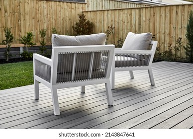 Photography Of A Suburban Family Home, Outdoor Furniture Setting In An Al Fresco Patio Area With A Garden And Back Fence In The Background.