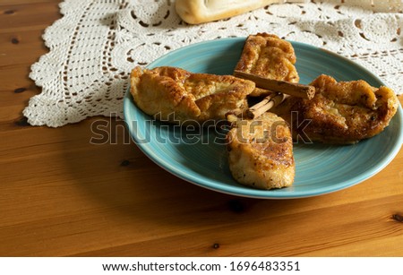 Photography of a typical Spanish dessert eaten during easter. Morning light.Cinnamon and bread.