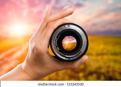 Photography View Camera Photographer Lens Lense Through Field Sunrise Sunset Sun Sky Cloud Video Photo Digital Glass Hand Blurred Focus People Concept - Stock Image