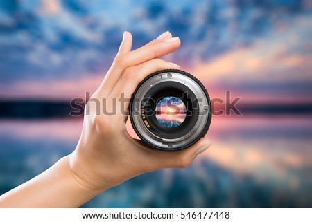 photography view camera photographer lens lense through video photo digital glass hand blurred focus people sun sunset sunrise cloud sky water lake concept - stock image
