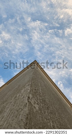 Photography of white fluffy clouds with blue sky at the angle of the building