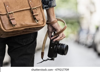 Photogrpher with leather bag in the city. Rear view - Powered by Shutterstock