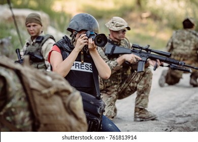 Photojournalist documenting war conflict. in the mountain. war, army, technology and journalist work concept.