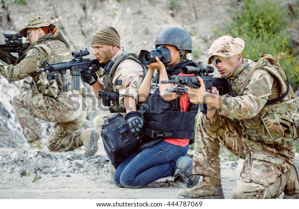 Photojournalist\
documenting war or rebel conflict in the mountain. war, army,\
technology and journalist work\
concept.