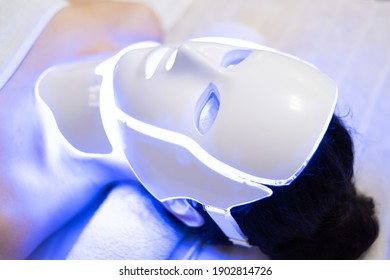 Photon Mask. Health And Beauty. Cosmetic Procedure For Woman Face. Beauty Laboratory. LED Facial Mask, Photon Therapy. Photo Shows The Different Modes, Colors