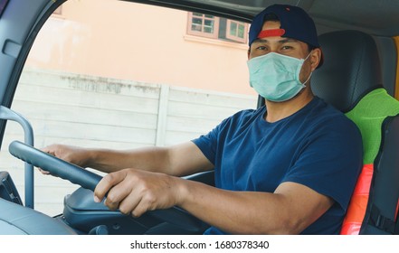 Photos Of Asian Truck Drivers Wearing Masks To Protect Against Dust And The Spread Of COVID 19 In Front Of The Car. Safety Ideas For A Worker In The Transportation Business. And Is A New Normal Life.