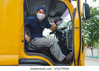 Photos Of Asian Truck Drivers Wearing Masks To Protect Against Dust And The Spread Of COVID 19 In Front Of The Car. Safety Ideas For A Worker In The Transportation Business. And Is A New Normal Life.