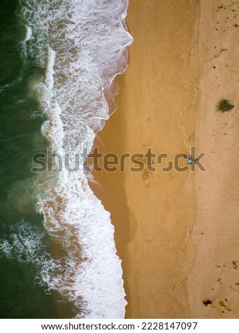 Similar – Luftaufnahme von fliegenden Drohnen von Menschen, die sich am Algarve Beach in Portugal entspannen.