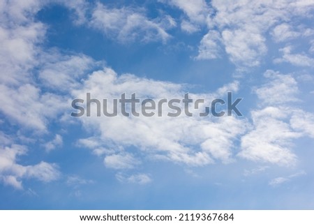 Photos of the cloudy sky. Tiny white clouds in the blue sky.