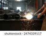 Photos of factory workers welding steel