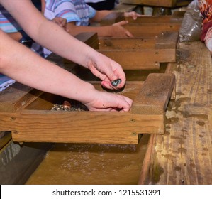 A Photos Showing A Child's Hand Using A Gold Sifter Panning For Gold And Gems A Great Educational Outdoor Acitivity With Kids