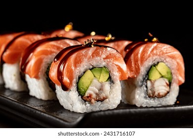 Photos of sushi, rolls, Japanese cuisine, isolated on a black background with kitchen utensils - Powered by Shutterstock