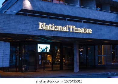Photos taken of the National Theatre London, UK on the 27th November 2019. Photos show the main entrance and surrounding area. Walkers on South Bank, River Thames are aslo visible within the frame.
