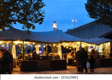 Photos taken on the 27th November 2019 in Southbank London United Kingdom. Photos show street food service, people strolling, bars and restaurants. Photos taken late evening along the river thames.