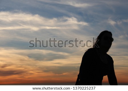 Similar – Image, Stock Photo Young woman with pipe backlit by the sea in the midnight sun