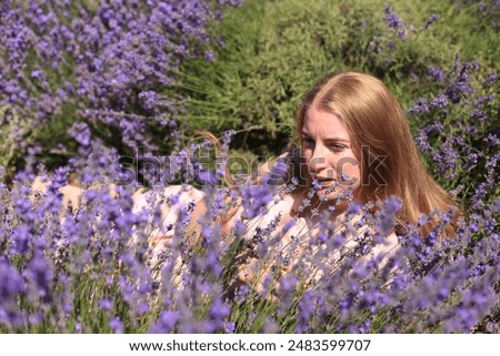 Similar – eine frau vor  einer blumenwiese. blumen pflücken