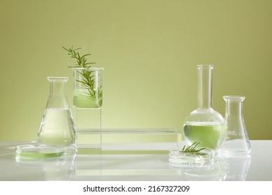Photoshoot over the course of experiment on green leaf , the research on chemistry lab , fluid in beaker and laboratory equipment and transparent podium with blank space for product