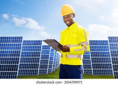Photovoltaic Green Energy Technology. Worker At Solar Panel Plant