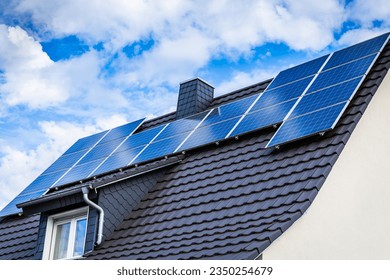 Photovoltaic panels on the roof of family house, solar panels. Environment and technology concepts. - Shutterstock ID 2350254679