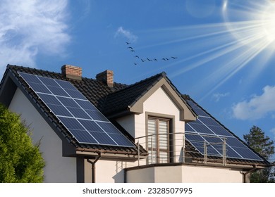 Photovoltaic panels on the roof. Modern house and solar energy. Sun rays and greenery. The concept of a sustainable environment, construction. - Shutterstock ID 2328507995
