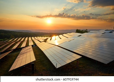 Photovoltaic panels of solar power station in the landscape at sunset. View from above.