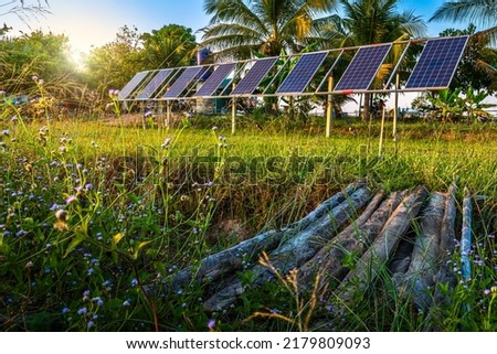 photovoltaic solar power panel for agriculture in a rural houses area Agricultural fields blue sky background,Agro-industry of household Rural style in Thailand, smart farm alternative clean energy. 商業照片 © 