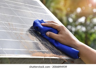 Photovoltaic Surface Is Cleaned By Hand Hold Cloth To Clean Dirty And Dusty. Concept : Cleaning Surface Of Photovoltaic Panels To Get High Quality And Efficiency Of Taking Power Energy From The Sun. 