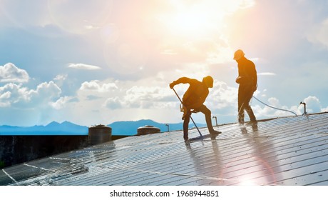 Photovoltaic Technicians Were Cleaning And Washing The Surface Of The Solar Panels Which Had Dust And Birds' Pooping 