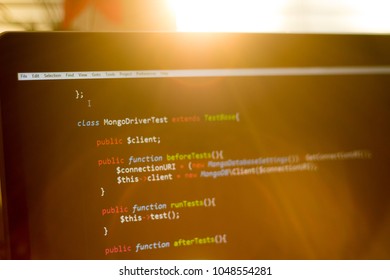 PHP back-end code in sunset rays. Computer programming source code. 