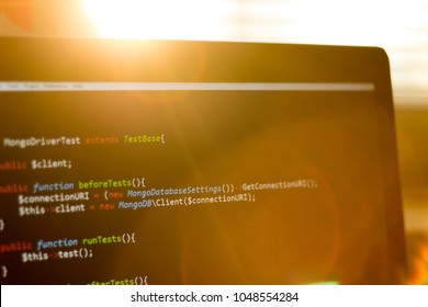 PHP back-end code in sunset rays. Computer programming source code. 