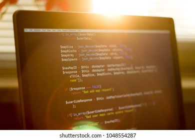 PHP back-end code in sunset rays. Computer programming source code. A