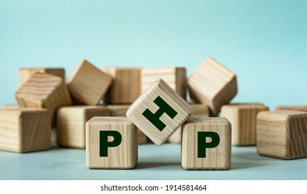 PHP (Hypertext Preprocessor) - acronym on wooden cubes on a light background. Business concept