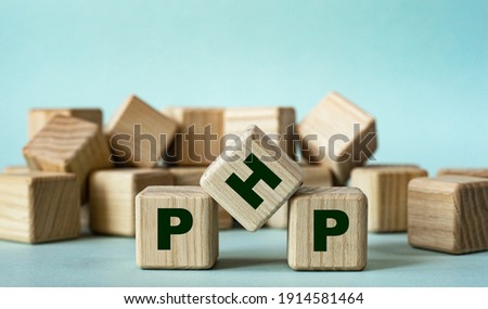 PHP (Hypertext Preprocessor) - acronym on wooden cubes on a light background. Business concept