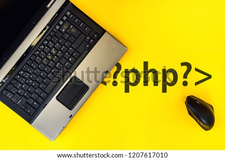 PHP programming language,. laptop and vertical mouse on yellow background with php tag