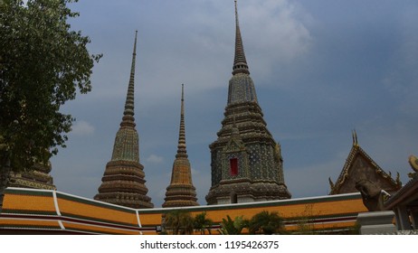 Phra Maha Chedi Si Rajakarn, A Group Of Four Huge Pagodas Surrounded By White Wall With Thai-Chinese Style Sheltered Gates Decorated With Colour-glazed Inside Wat Pho Complex In Bangkok, Thailand