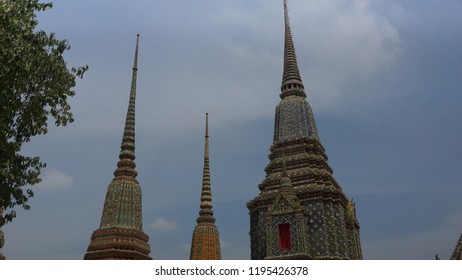 Phra Maha Chedi Si Rajakarn, A Group Of Four Huge Pagodas Surrounded By White Wall With Thai-Chinese Style Sheltered Gates Decorated With Colour-glazed Inside Wat Pho Complex In Bangkok, Thailand