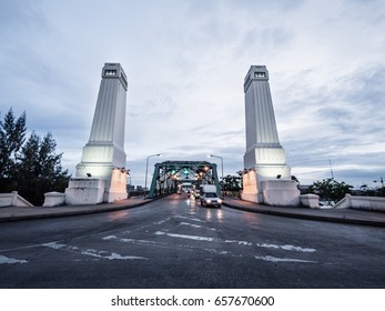 Phra Phuttha Yodfa Bridge cross Chao Praya river in Bangkok, Thailand. Cityscape of river bridge in cloudy day, motion blur with car on road. Beautiful grand dual pillar structure in twilight time. - Powered by Shutterstock