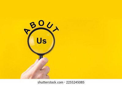 Phrase about us with magnifying glass on yellow background - Shutterstock ID 2255245085