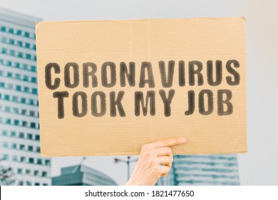The phrase " Coronavirus Took My Job " on a banner in men's hand with blurred background. Economical crisis. Pandemic. Covid-19. Lost. Profession. Unemployment