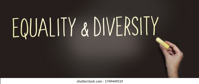 The phrase Equality and Diversity written by hand in white chalk on a used blackboard as a reminder of equality for all. Social gender issues question problems concept.