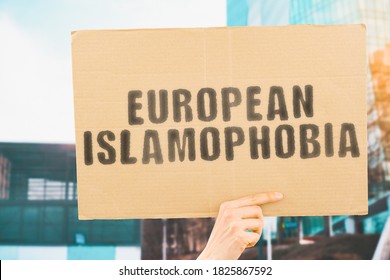 The phrase " European Islamophobia " on a banner in men's hand with blurred background. Human Rights. Equality. Diversity. Dangerous. Aggression