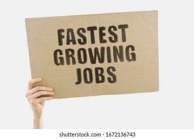 The phrase " Fastest Growing Jobs " on a banner in hand. Human holds a cardboard with an inscription. Education. Specialist. Profession. Opportunities. Future. Money. Earnings. Revenue - Shutterstock ID 1672136743