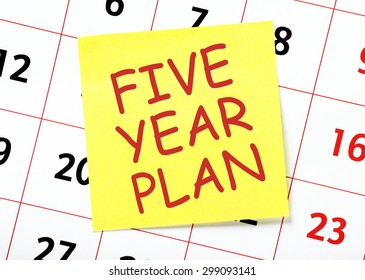 The Phrase Five Year Plan On A Yellow Sticky Note Posted On A Calendar Or Planner Page As A Reminder