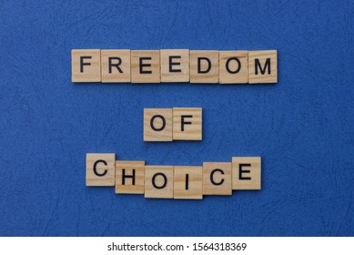 phrase freedom of choice made from brown wooden letters lies on a blue table - Shutterstock ID 1564318369