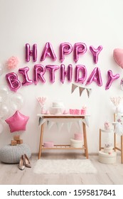 Phrase HAPPY BIRTHDAY Made Of Pink Balloon Letters In Decorated Room