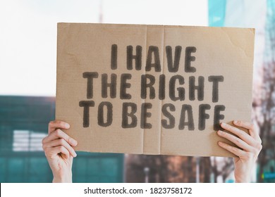 The phrase " I have the right to be safe " on a banner in men's hand with blurred background. Safety. Security. Dangerous. Government. Protection. Privacy. Safeguard