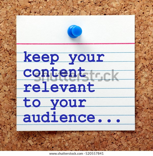 The phrase Keep Your
Content Relevant to Your Audience in blue text on a note card
pinned to a cork notice board as a reminder for your social media
marketing strategy