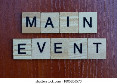 Phrase Main Event Made From Gray Wooden Letters Lies On A Brown Background