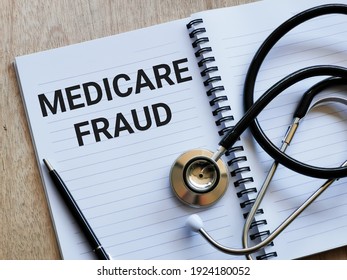 Phrase MEDICARE FRAUD Written On Note Book With Stethoscope And A Pen. Medical And Health Concept.